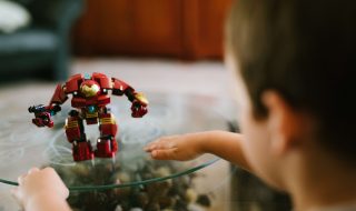 How To Get A Stylish, Yet Kid-Friendly Living Room - Glass Coffee Table With Child's Transformer Toy
