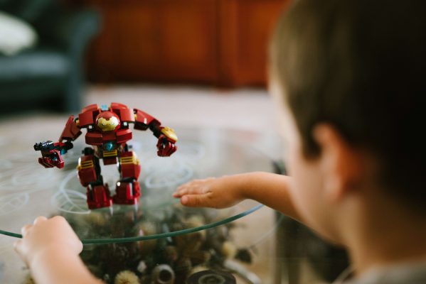 How To Get A Stylish, Yet Kid-Friendly Living Room - Glass Coffee Table With Child's Transformer Toy