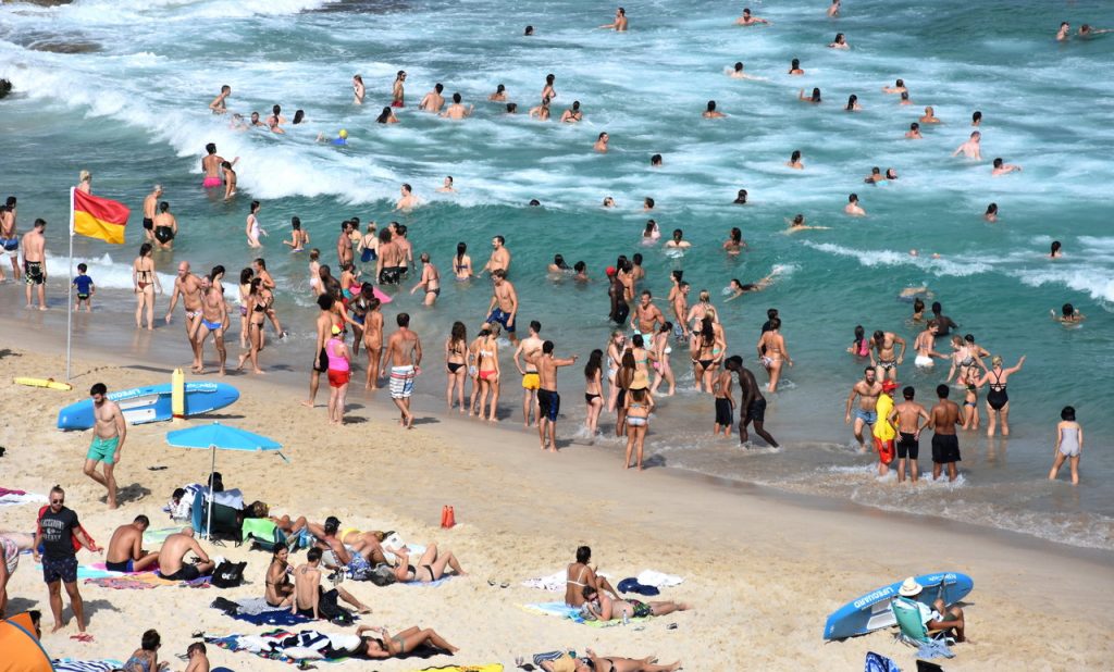 Sydney, Australia -People relaxing, swimming and sun bathing on Tamarama beach.