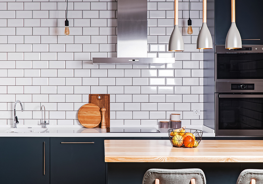 Blue kitchen with white metro tiles