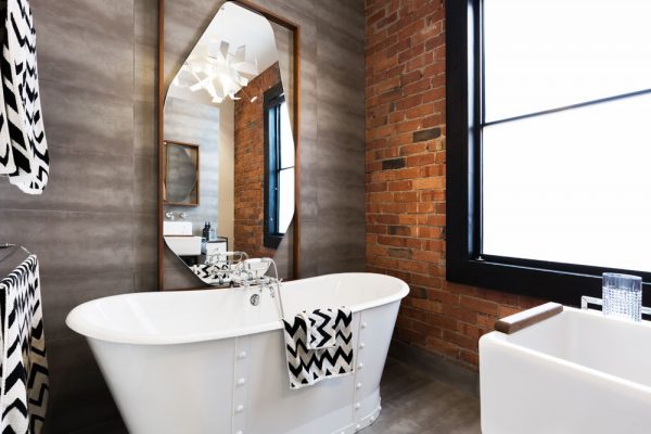 Bathroom with roll top bath and large mirror