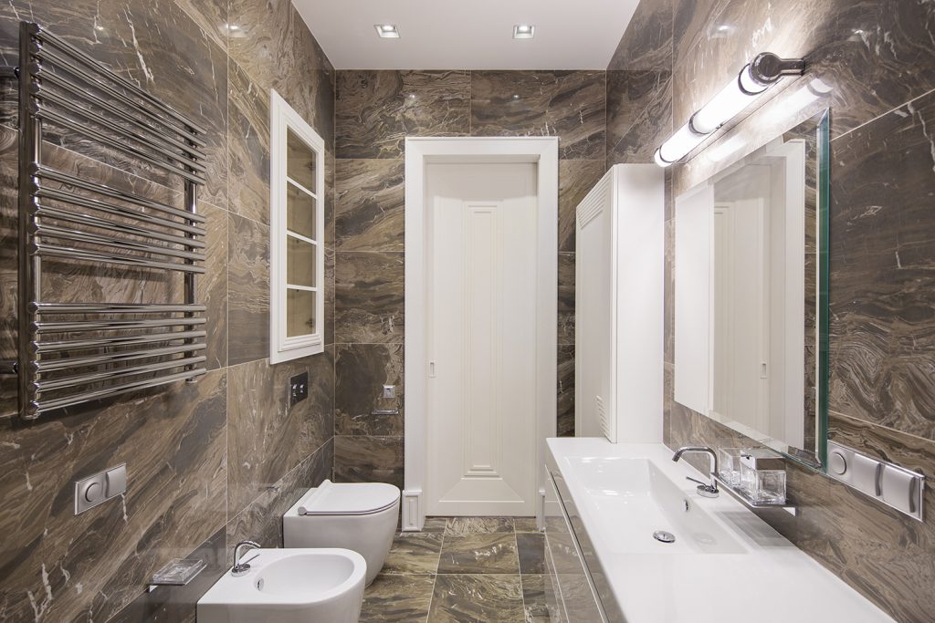 Dark Tiled bathroom with light over bathroom mirror