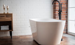 Large white bath with black stand alone taps