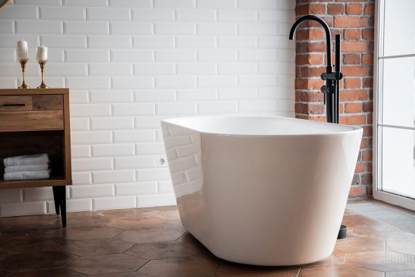 Large white bath with black stand alone taps