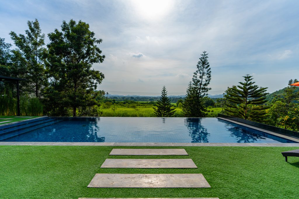 Infinity Swimming Pool surrounded by grass