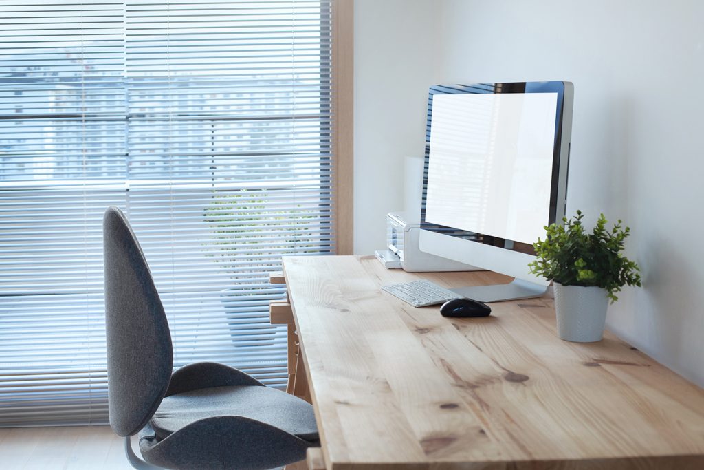 Comfortable grey office chair and desk.