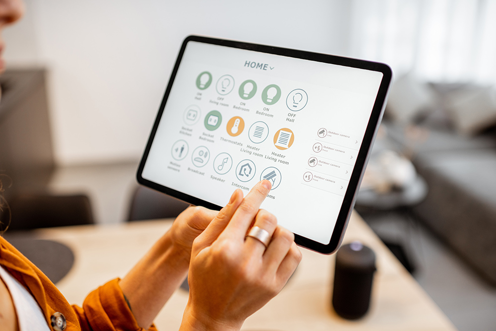 Young woman controlling home with a digital touch screen panel. Smart Home