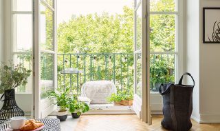 Apartment with wooden flooring leading to french doors and balcony