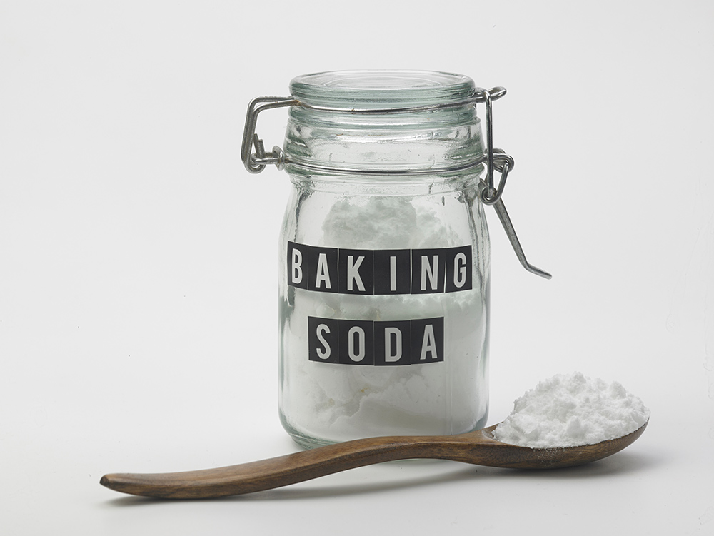 Baking Soda in jar and on wooden spoon