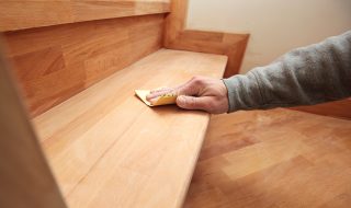 Wooden staircase being sanded by hand
