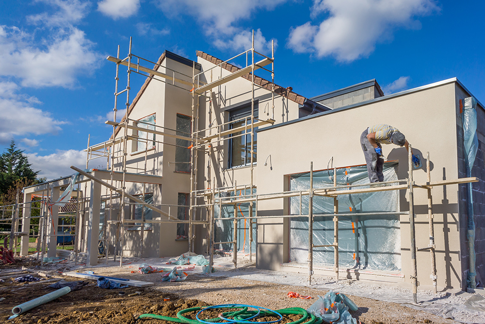 Large house being built and surrounded by scaffolding